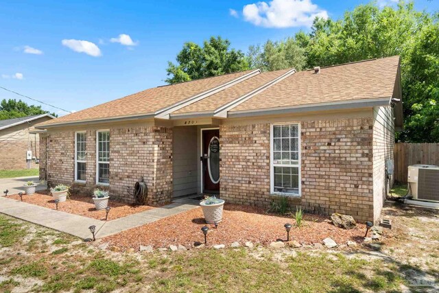 4701 Kitty Hawk Cir, Gulf Breeze, FL 32563 - ranch-style home with central air condition unit, a shingled roof, and brick siding