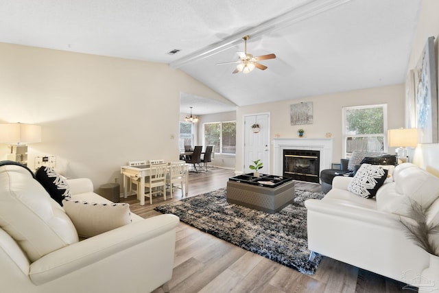 4701 Kitty Hawk Cir, Gulf Breeze, FL 32563 - living area with plenty of natural light, a ceiling fan, wood finished floors, and a glass covered fireplace