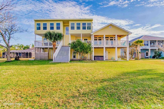 rear view of house featuring a yard and a jacuzzi