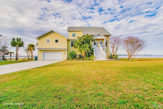 view of front of home featuring a front yard and a garage