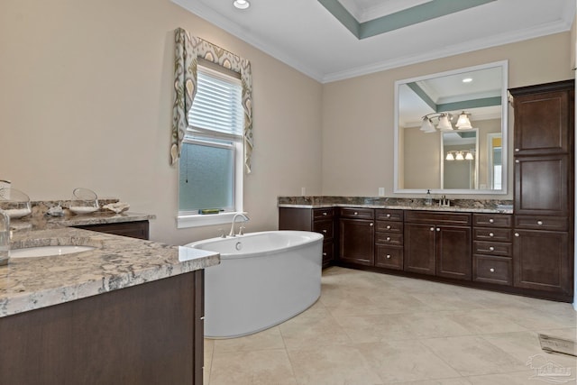 bathroom with a healthy amount of sunlight, a bathing tub, ornamental molding, and vanity