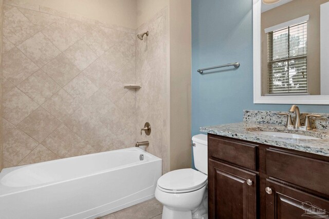 full bathroom featuring tile patterned flooring, vanity, toilet, and tiled shower / bath