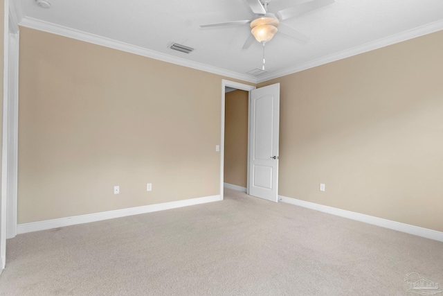 carpeted spare room with crown molding and ceiling fan