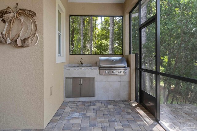 unfurnished sunroom featuring sink