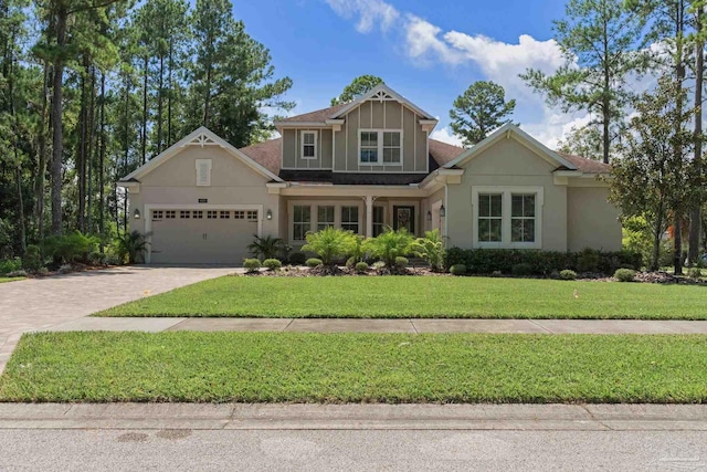 view of front of home with a garage and a front lawn