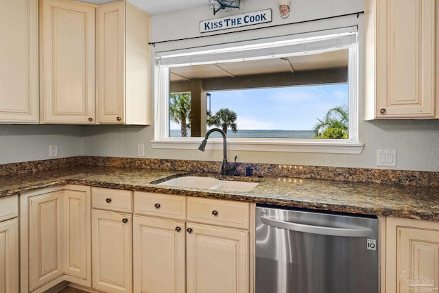 2950 Coral Strip Pkwy, Gulf Breeze, FL 32563 - kitchen featuring dishwasher, a sink, cream cabinetry, and dark stone counters