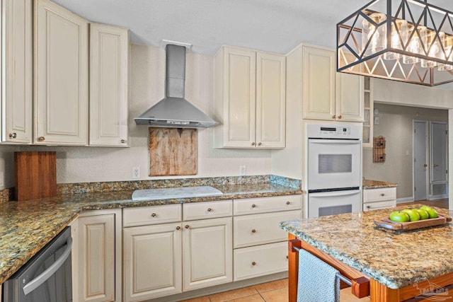 2950 Coral Strip Pkwy, Gulf Breeze, FL 32563 - kitchen with wall chimney range hood, white appliances, and cream cabinets