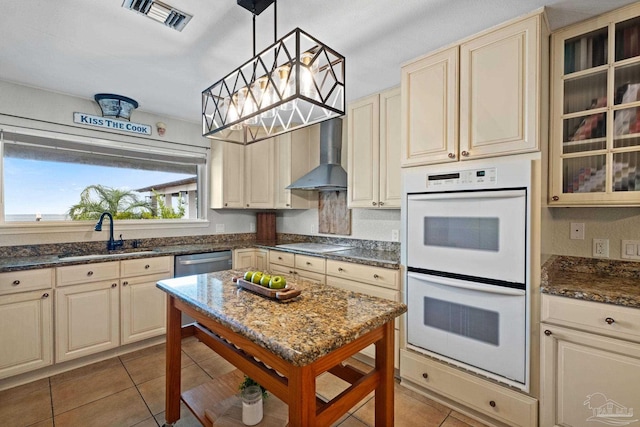 2950 Coral Strip Pkwy, Gulf Breeze, FL 32563 - kitchen featuring cream cabinetry, double oven, a sink, electric cooktop, and tile patterned flooring