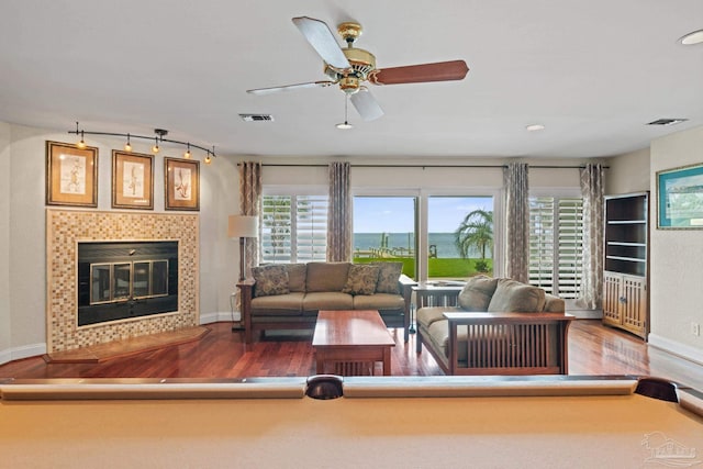 2950 Coral Strip Pkwy, Gulf Breeze, FL 32563 - living area with wood finished floors, baseboards, a ceiling fan, a tiled fireplace, and recessed lighting
