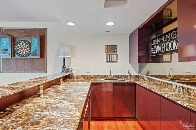 2950 Coral Strip Pkwy, Gulf Breeze, FL 32563 - kitchen featuring a sink, stone countertops, light wood-style floors, and recessed lighting