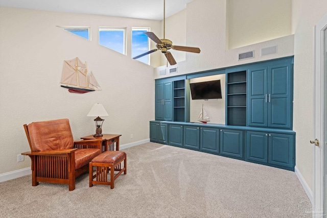 2950 Coral Strip Pkwy, Gulf Breeze, FL 32563 - sitting room with a ceiling fan, carpet, baseboards, and a towering ceiling