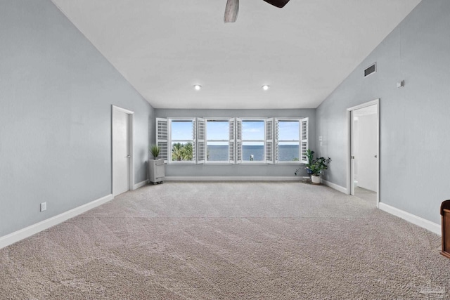 2950 Coral Strip Pkwy, Gulf Breeze, FL 32563 - carpeted empty room with vaulted ceiling, baseboards, ceiling fan, radiator, and a water view
