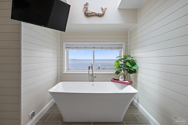 2950 Coral Strip Pkwy, Gulf Breeze, FL 32563 - bathroom with tile patterned floors, wooden walls, a freestanding bath, and a water view