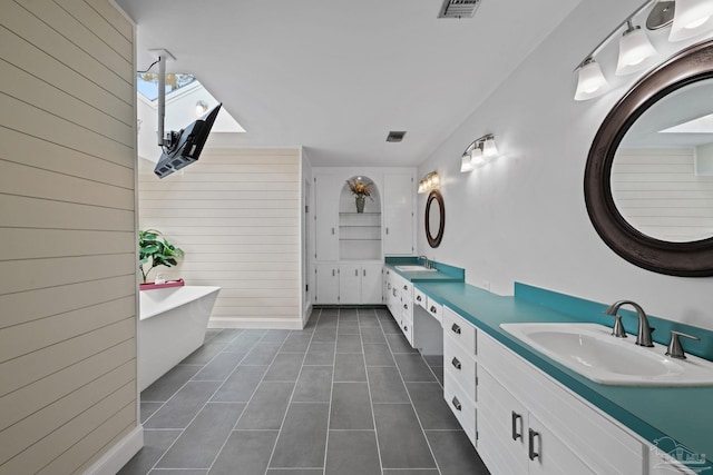 2950 Coral Strip Pkwy, Gulf Breeze, FL 32563 - bathroom featuring wood walls, tile patterned flooring, double vanity, and a freestanding bath