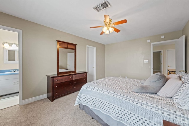 2950 Coral Strip Pkwy, Gulf Breeze, FL 32563 - bedroom with light carpet, a sink, baseboards, ensuite bathroom, and ceiling fan