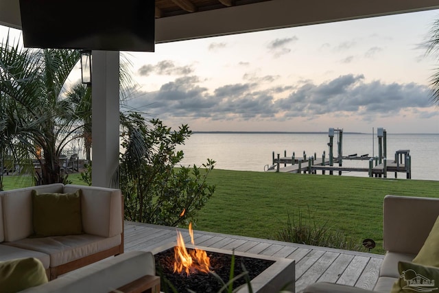 2950 Coral Strip Pkwy, Gulf Breeze, FL 32563 - deck featuring a water view, a dock, boat lift, a lawn, and an outdoor living space with a fire pit