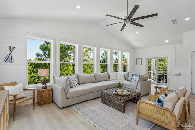 living room with ceiling fan, sink, vaulted ceiling, and light wood-type flooring