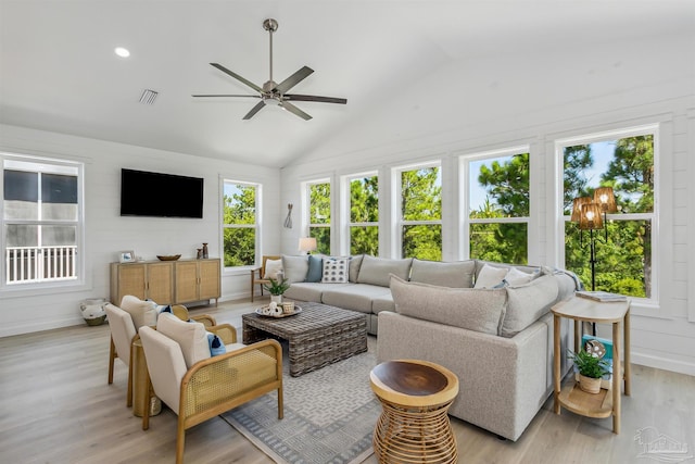 living room featuring vaulted ceiling, ceiling fan, and light hardwood / wood-style floors