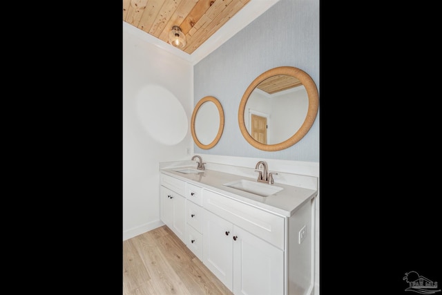 bathroom featuring vanity, hardwood / wood-style flooring, ornamental molding, and wooden ceiling