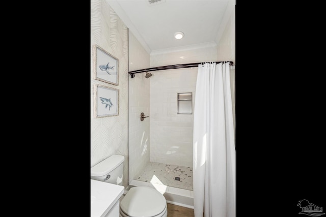 bathroom with ornamental molding, toilet, a shower with shower curtain, and vanity