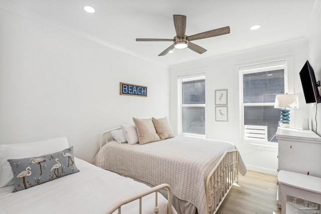 bedroom with ceiling fan and light hardwood / wood-style flooring