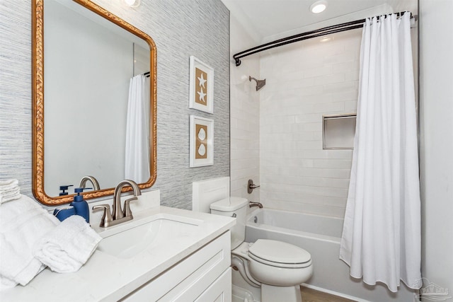 full bathroom with vanity, shower / tub combo, and toilet