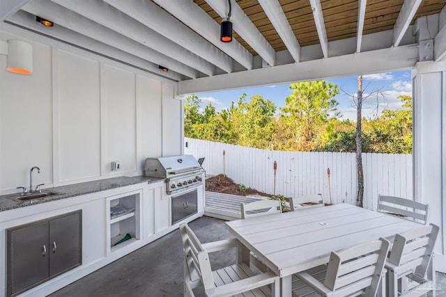 view of patio with exterior kitchen, sink, and grilling area