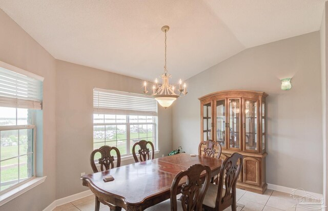 dining space featuring light tile patterned floors, lofted ceiling, and plenty of natural light