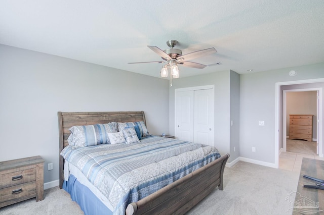 carpeted bedroom featuring ceiling fan and a closet