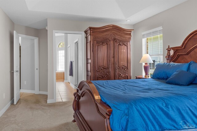 bedroom featuring ceiling fan, a closet, and light colored carpet