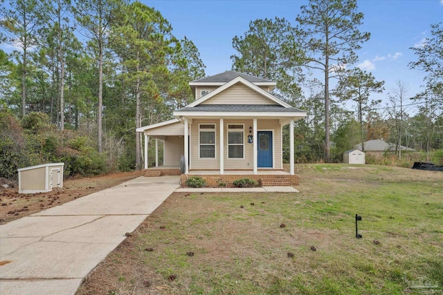 view of front of house featuring a porch, a shed, and a front yard