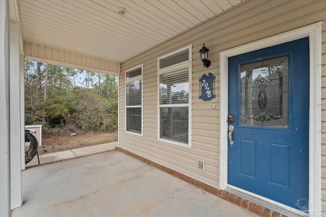 view of exterior entry with covered porch