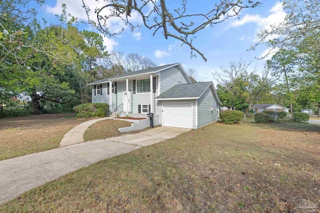 split foyer home with a garage, driveway, a front yard, and roof with shingles