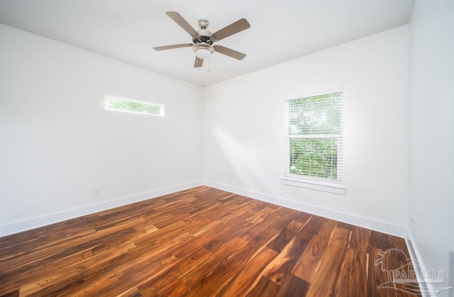 empty room featuring dark wood-type flooring and ceiling fan