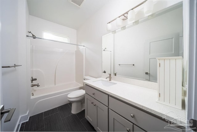 full bathroom featuring bathtub / shower combination, vanity, and toilet