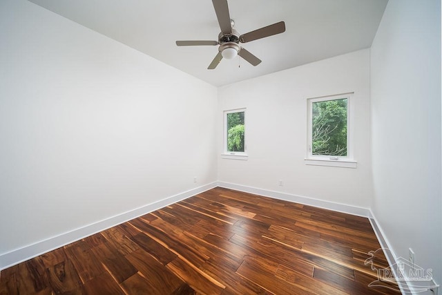 empty room with dark wood-type flooring and ceiling fan