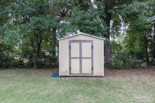 view of outbuilding featuring a lawn