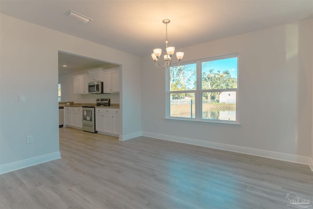 interior space featuring a chandelier and light hardwood / wood-style flooring