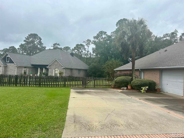 view of side of property with a garage and a lawn