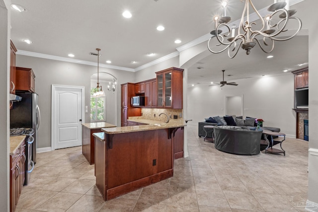 4166 Madura Four, Gulf Breeze, FL 32563 - kitchen with a ceiling fan, a chandelier, light stone counters, glass insert cabinets, and backsplash