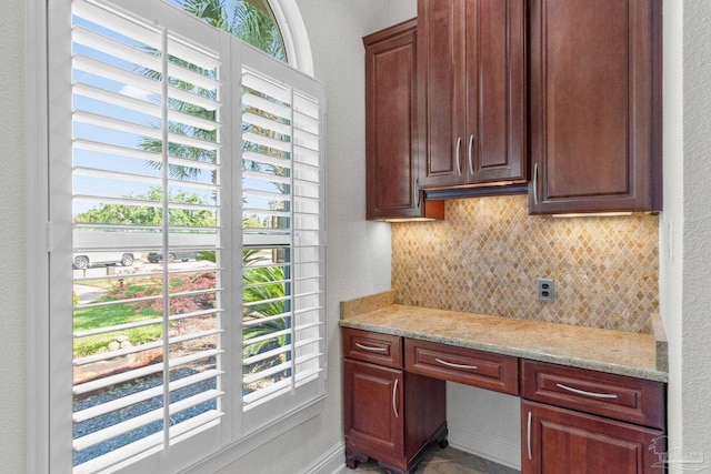 4166 Madura Four, Gulf Breeze, FL 32563 - kitchen featuring backsplash, healthy amount of natural light, and light stone counters