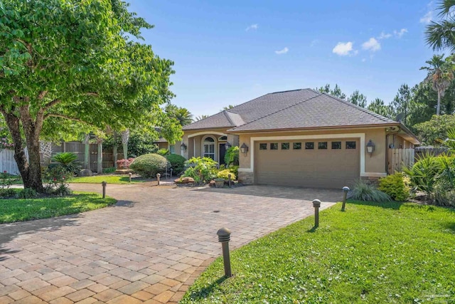 4166 Madura Four, Gulf Breeze, FL 32563 - view of front facade with stucco siding, a garage, decorative driveway, and stone siding