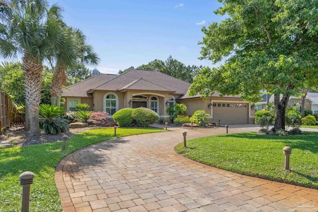 4166 Madura Four, Gulf Breeze, FL 32563 - view of front of home with stucco siding, curved driveway, and an attached garage