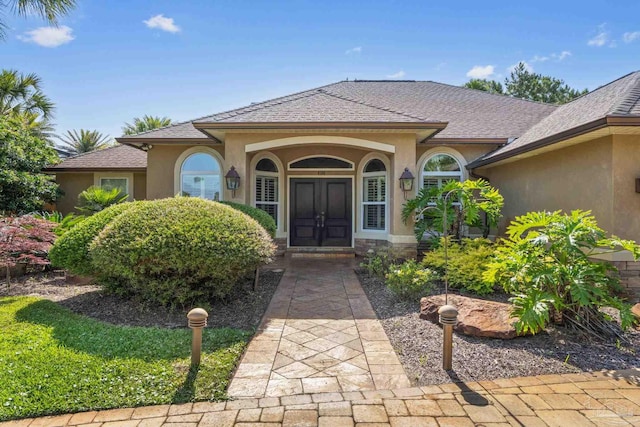 4166 Madura Four, Gulf Breeze, FL 32563 - view of exterior entry with stucco siding and french doors