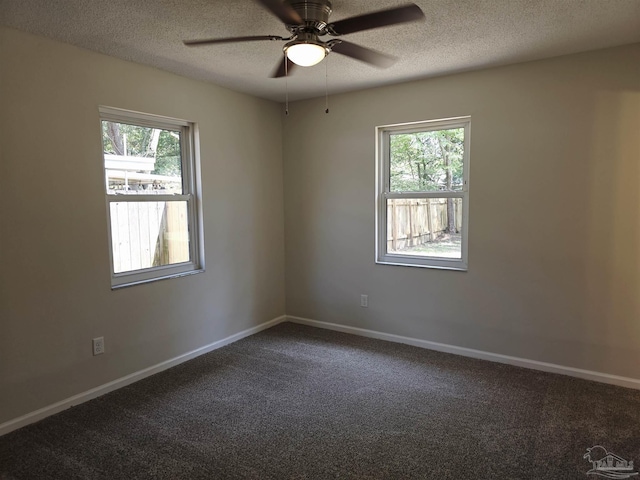 5666 Vestavia Ln, Pensacola, FL 32526 - empty room featuring dark carpet, a wealth of natural light, and a textured ceiling