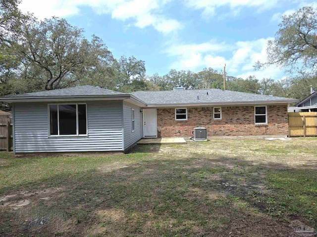 5666 Vestavia Ln, Pensacola, FL 32526 - rear view of house featuring a yard, fence, central air condition unit, brick siding, and roof with shingles