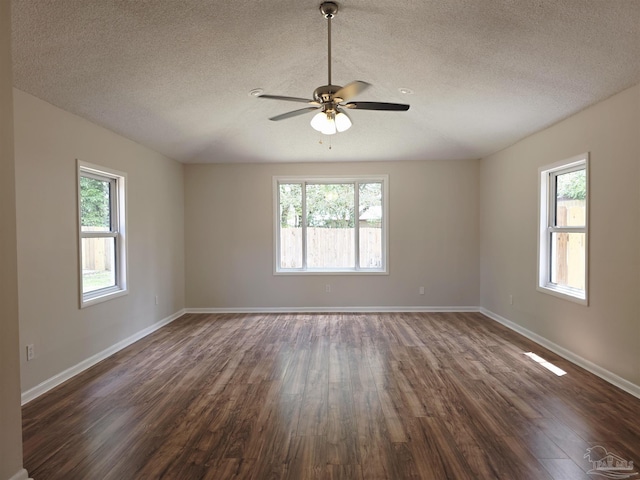 5666 Vestavia Ln, Pensacola, FL 32526 - spare room featuring dark wood-type flooring, a wealth of natural light, and a textured ceiling