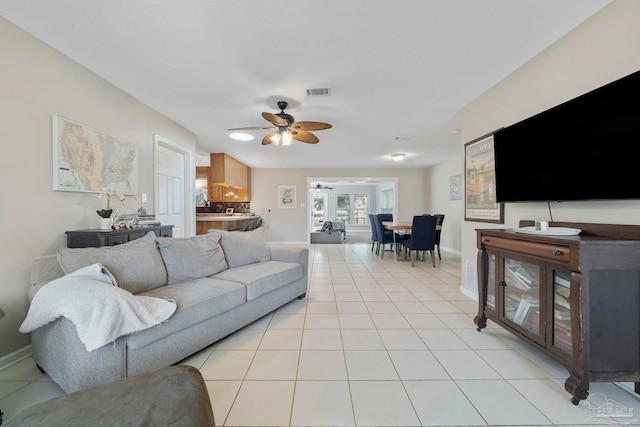 tiled living room featuring ceiling fan