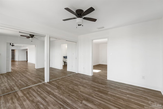 interior space with ceiling fan and dark hardwood / wood-style floors