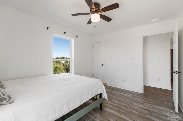 bedroom with dark wood-type flooring and ceiling fan